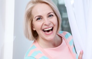 Attractive middle aged woman relaxing at home. The beautiful face close up.
