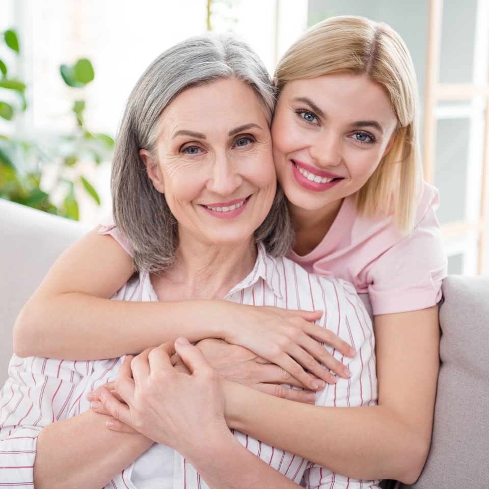 Photo of happy nice mother and daughter hug smile good mood free time weekend indoors inside house home
