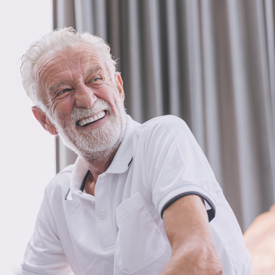 happy elderly man healthy senior confident smile with beautiful white teeth from denture prosthetics.